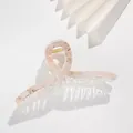 Macro detail of 13cm marble print hair claw clip with golden spring and acrylic teeth - Light Pink Amber Marble (B)