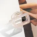 Macro shot of rectangular hollow hair claw with pearlescent texture and gold spring - Phantom Pink