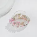Close-up of marble pattern hair claw clip with floral accents and sparkling rhinestones - Pink Brown Marble Style (F)