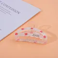 Detailed view of translucent strawberry pattern hair claw with French lettering - Semi-circle Strawberry / Medium