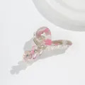Detail of acrylic flower hair claw with marble texture and rhinestone center - Rose Red