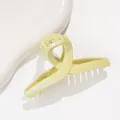 Detailed view of light green hair claw clip with fine glitter coating and metal spring - Green