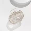 Macro detail of a minimalist grey marble acetate hair claw with a gold metal spring - Transparent Grey Marble (C)