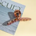 Close-up of large acrylic hair claw clip with tortoise shell and rose gold glitter finish - Dark Brown