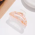 Close-up of translucent pink hair claw clip with golden veins and metal spring detail - Hot Pink Gold Marble (F)