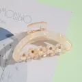 Detailed shot of 9cm acrylic hair claw clip with floral pearl and rhinestone accents - Champagne Gold