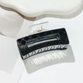 Close-up of black quilted pattern hair claw clip with rectangular hollow out design - Medium / Black
