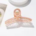 Close-up of translucent peach acetate hair claw clip with elegant twisted ring design - Peach Pink Twisted Style (Pink)
