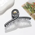 Close-up of a large black and gray tortoiseshell hair claw clip with a gold metal spring - Black And Gray Color Blocking (Dark Gray)