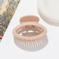 Close-up of small matte oval hair claw clip in apricot finish with round plastic teeth - Light Khaki