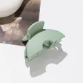 Detail of mint green matte finish mini hair claw clip with metal spring and arc design - Green