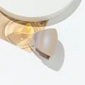 Macro shot of glittery triangular claw clip on a minimalist display stand - Khaki