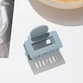 Detail view of a matte misty blue square hair claw clip with a round handle - Sky Blue