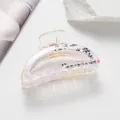 Detail of a Chinese style acetic hair claw with calligraphy and pearlescent texture - Pink