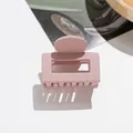 Detail of a dusty pink matte square hair claw clip with cutout design on white background - Pink Purple