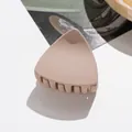 Close-up of matte nude cat-ear hair claw clip with interlocking teeth for daily styling - Light Khaki