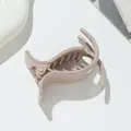 Close-up of a nude pink glitter hair claw clip with durable metal spring for kids - Khaki