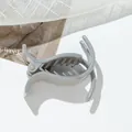 Detailed view of grey glitter shark hair claw clip with frosted texture on mesh background - Gray