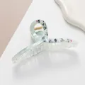 Detailed macro view of 13cm green marble acetate hair claw with Chinese calligraphy design - Green