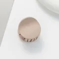 Macro detail of round matte hair claw clip in elegant beige finish for thin hair styling - Light Khaki