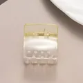 Detail view of square transparent hair claw clip with golden spring on purple background - Two-tone Champagne (Yellow) / Yellow