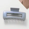 Macro detail of glossy blue-grey square hair claw clip with metallic pearl finish - Gray