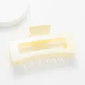 Close-up of a 12cm cream rectangle shark hair claw clip with a subtle pearly finish - Off-white