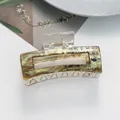 Detail view of retro green marble hair claw clip with Chinese calligraphy and gold accents - Yellow