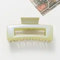 Macro detail of glossy light green square hair claw clip with pearlescent shimmer finish - Green