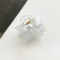 Detailed view of iridescent butterfly hair claw with white pearl and gold metal spring - Sky Blue