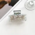 Detail of transparent hair claw clip with mother-of-pearl flowers and sparkling rhinestones - Gray