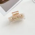 Detail view of transparent amber flower hair claw with white floral rhinestones decoration - Brown