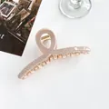 Macro shot of 13cm shark hair clip showing checkered texture and gold spring detail - Light Khaki