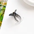 Detailed side view of a gradient grey hair claw clip on a clean white surface - Black