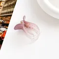 Macro shot of a translucent purple gradient hair claw clip on a minimalist white table - Purple