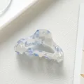 Detail view of the blue marble acetate hair claw clip with its elegant smooth textures - Sky Blue