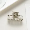 Primer plano de una pinza para el cabello rectangular de acetato con textura de mármol gris - Gris