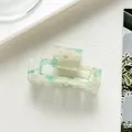 Detail of rectangular acetate hair claw with mint green and cream marble texture - Green