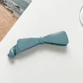 Detailed view of dusty blue bow-shaped banana hair clip with glossy polished finish - Sky Blue