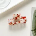 Vista superior de una pinza para el pelo rectangular de acetato con textura de mármol rojo y blanco - Rojo