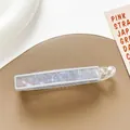 Macro shot of blue iridescent shell texture inside a transparent barrette hair clip - Light Gray