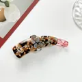 Detail view of flower banana clip with tortoise resin and sparkling champagne rhinestones - Rose Red and Dark Coffee