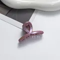 Close-up of elegant lavender glitter hair claw clip with a stylish twisted design - Pink