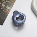 Macro shot of 3.5cm glittery blue hair claw clip with model number Z-052 on white desk - Gray
