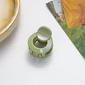 Detailed close-up of a mini green hair claw clip with a pearlescent glitter finish on white - Green