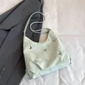 Mint green pleated shoulder bag with silver butterfly charms and chic half-moon shape - Green