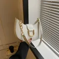 Minimalist white crescent shoulder bag with a gold D-ring buckle and decorative chain - White
