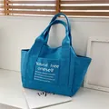 Dark blue canvas tote bag with front pocket and white lettering detail for women - Blue