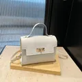 Mini white leather handbag with lychee texture and gold metal buckle closure - White