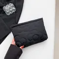 Black quilted floral pouch bag made of padded nylon fabric with a zip top closure - Black